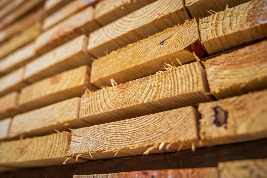 pexels-photo-12278589-12278589 Detailed close-up of neatly stacked wooden planks showing textures of natural lumber.