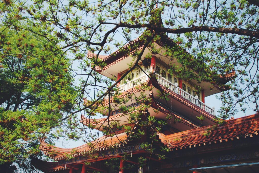 pexels-photo-2994878-2994878 Low angle shot of a traditional Asian pagoda with ornate architecture, nestled in a garden setting.